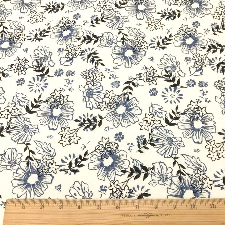 "Cream linen fabric with blue and black floral print – lightweight, breathable, 100% linen for dresses, tops, and tunics."

