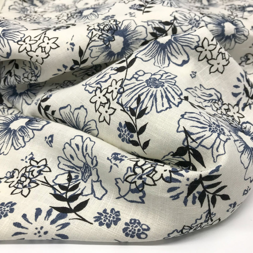 "Cream linen fabric with blue and black floral print – lightweight, breathable, 100% linen for dresses, tops, and tunics."

