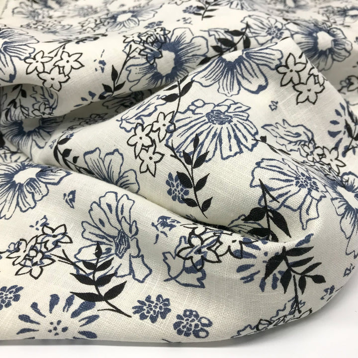 "Cream linen fabric with blue and black floral print – lightweight, breathable, 100% linen for dresses, tops, and tunics."

