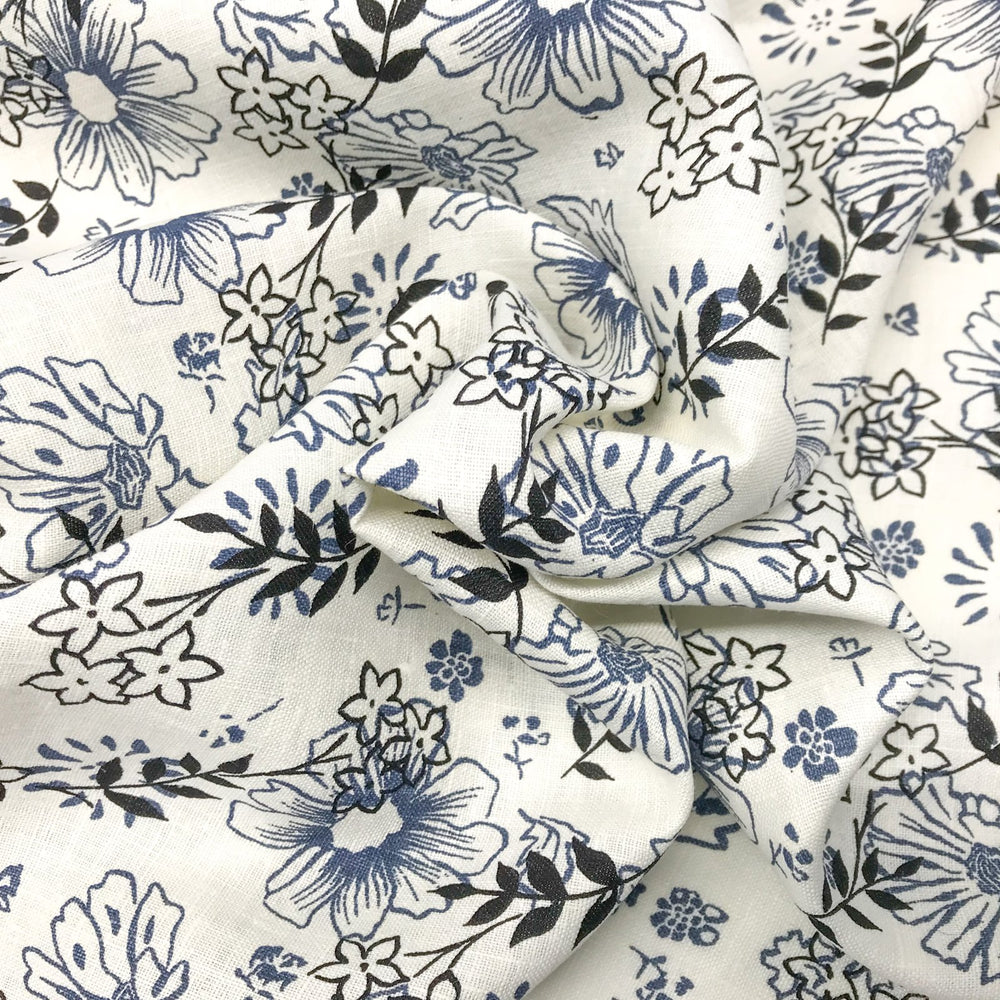 "Cream linen fabric with blue and black floral print – lightweight, breathable, 100% linen for dresses, tops, and tunics."

