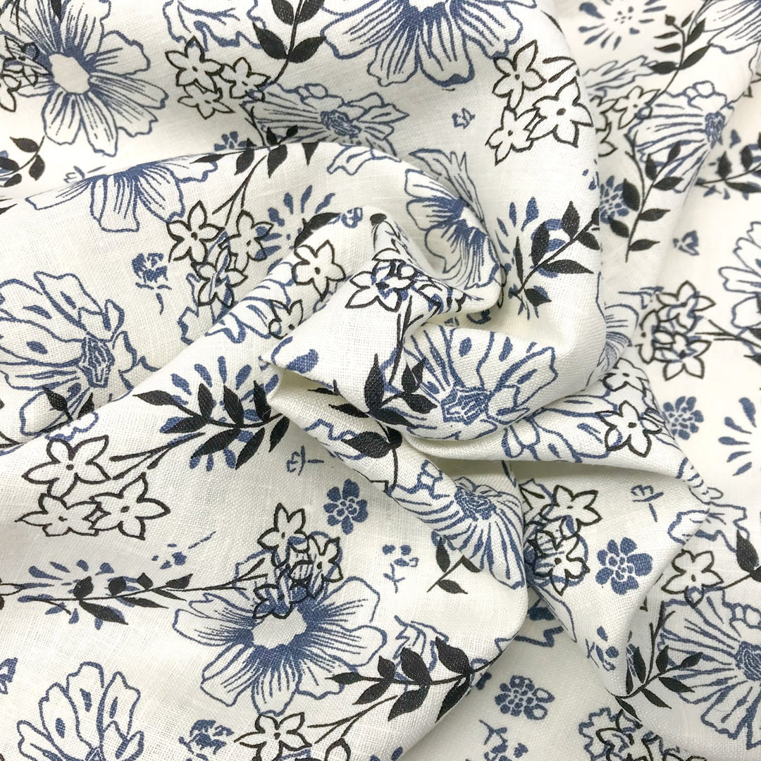 "Cream linen fabric with blue and black floral print – lightweight, breathable, 100% linen for dresses, tops, and tunics."

