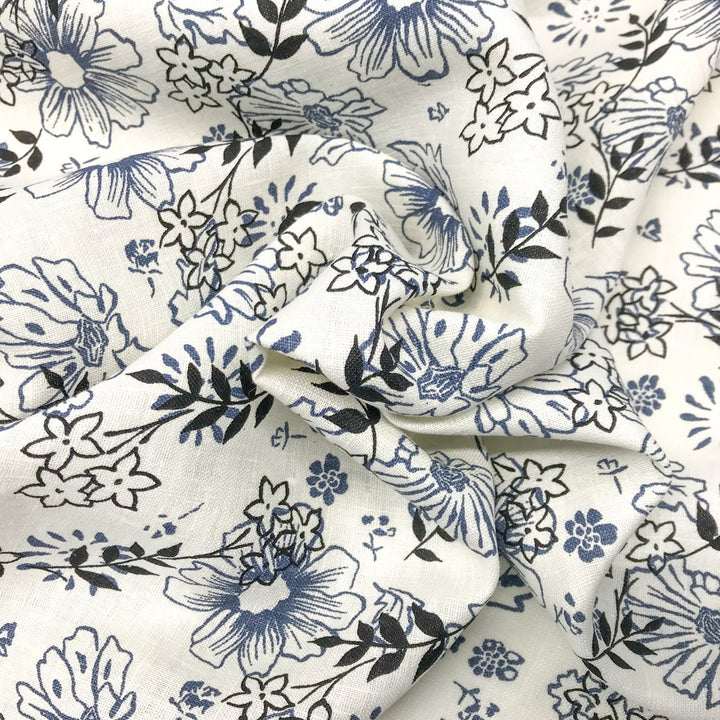 "Cream linen fabric with blue and black floral print – lightweight, breathable, 100% linen for dresses, tops, and tunics."

