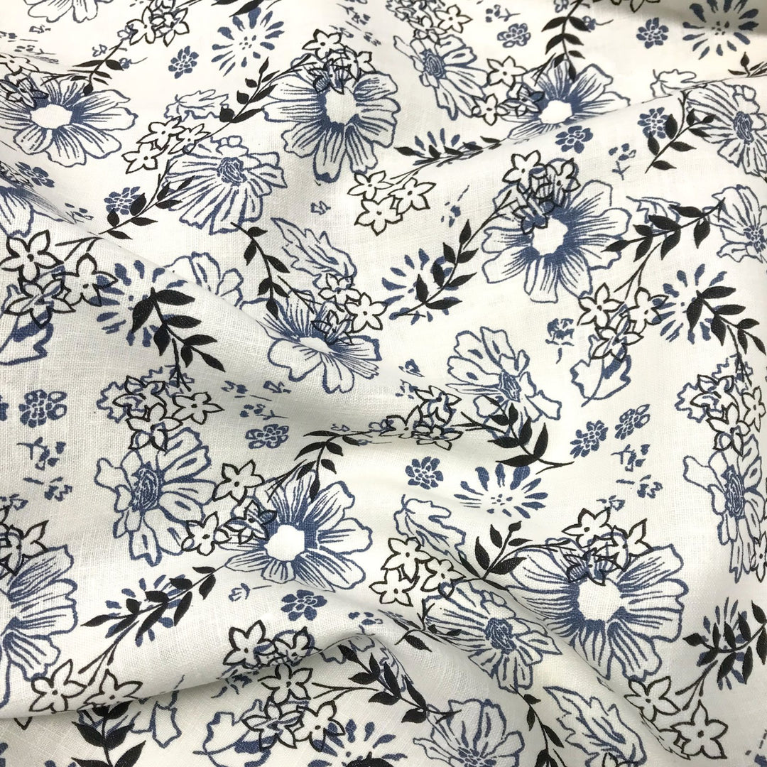 "Cream linen fabric with blue and black floral print – lightweight, breathable, 100% linen for dresses, tops, and tunics."

