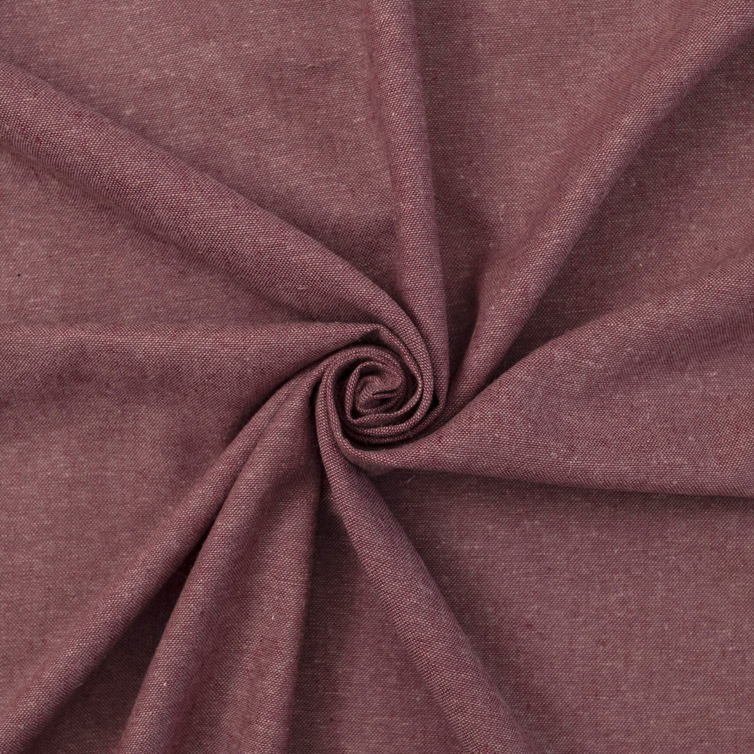 Close-up of Linen/Rayon Yarn Dye fabric in plum color showing textured yarn-dyed pattern and rich color variation.

