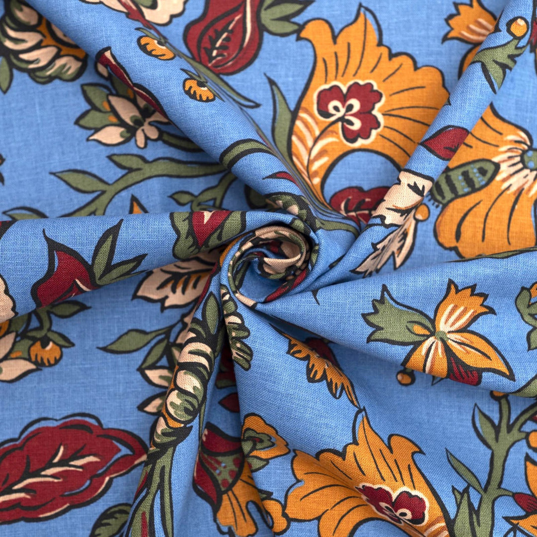Linen and cotton blend fabric – Bloomscape on cornflower blue by Zara, Italian deadstock with vibrant marigold, wine, and green floral print