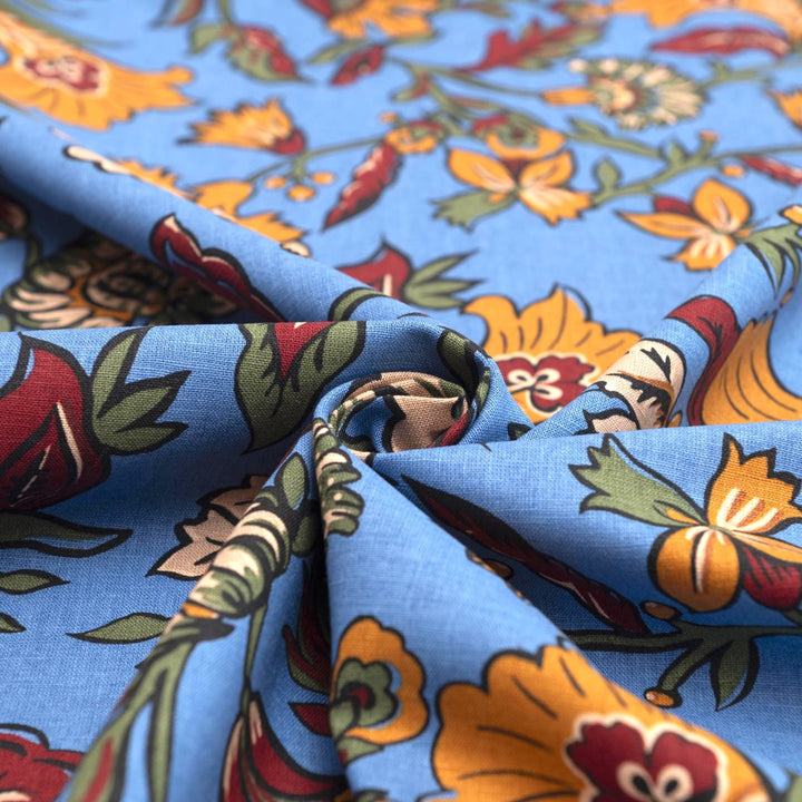 Linen and cotton blend fabric – Bloomscape on cornflower blue by Zara, Italian deadstock with vibrant marigold, wine, and green floral print