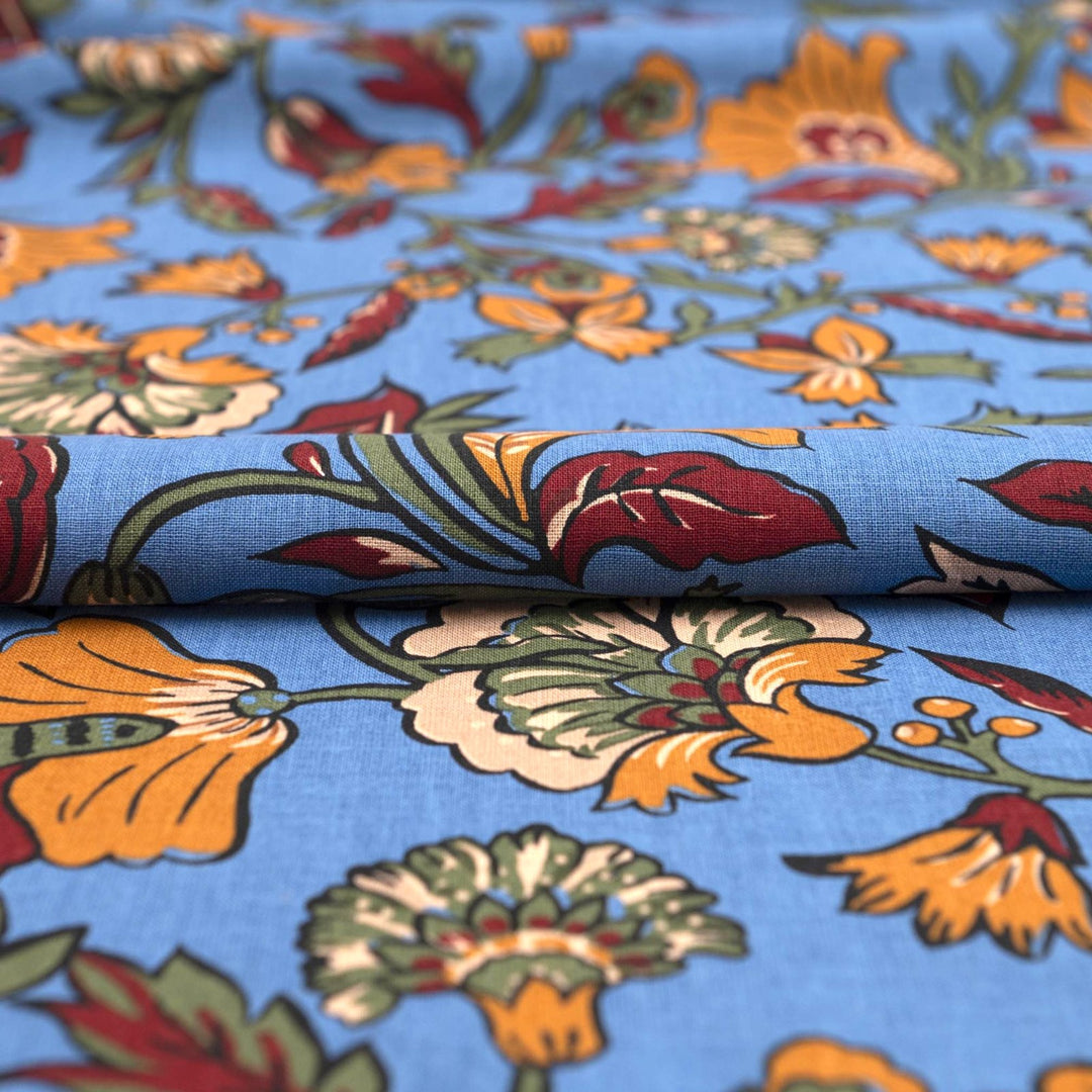 Linen and cotton blend fabric – Bloomscape on cornflower blue by Zara, Italian deadstock with vibrant marigold, wine, and green floral print