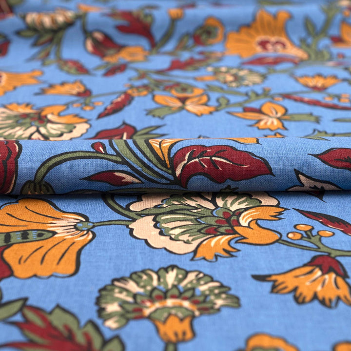 Linen and cotton blend fabric – Bloomscape on cornflower blue by Zara, Italian deadstock with vibrant marigold, wine, and green floral print