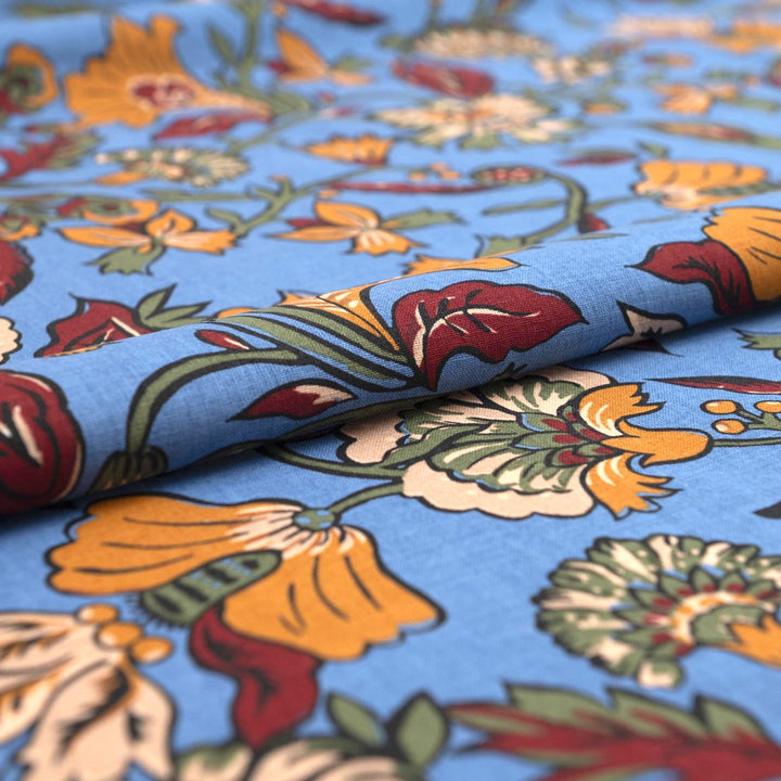 Linen and cotton blend fabric – Bloomscape on cornflower blue by Zara, Italian deadstock with vibrant marigold, wine, and green floral print