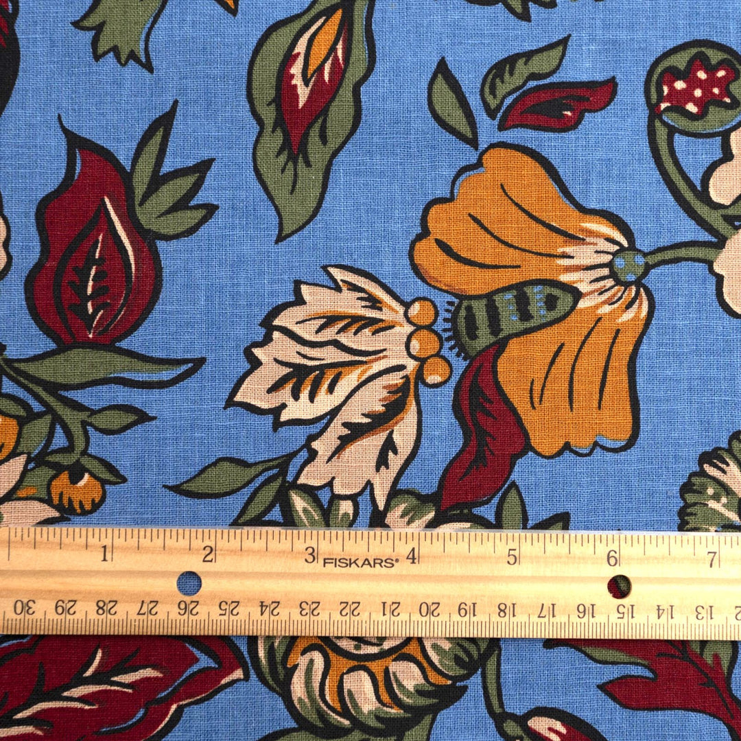 Linen and cotton blend fabric – Bloomscape on cornflower blue by Zara, Italian deadstock with vibrant marigold, wine, and green floral print
