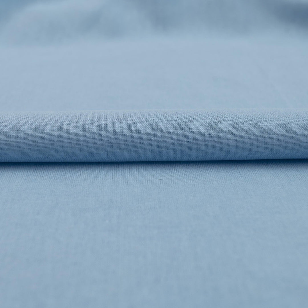 Pale blue linen and cotton blend fabric, mid-weight, soft, breathable, and opaque, perfect for sewing dresses, shirts, pants, and lightweight jackets.


