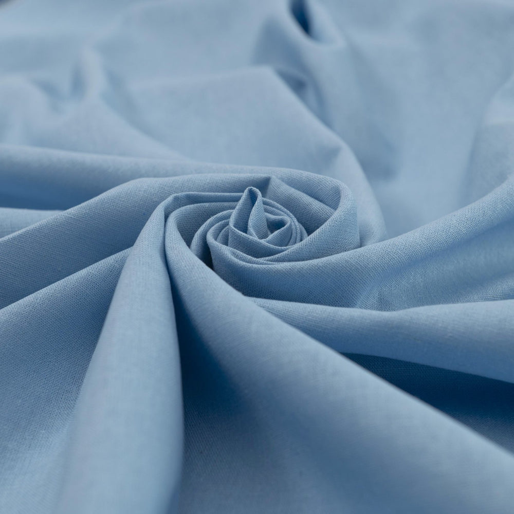 Pale blue linen and cotton blend fabric, mid-weight, soft, breathable, and opaque, perfect for sewing dresses, shirts, pants, and lightweight jackets.

