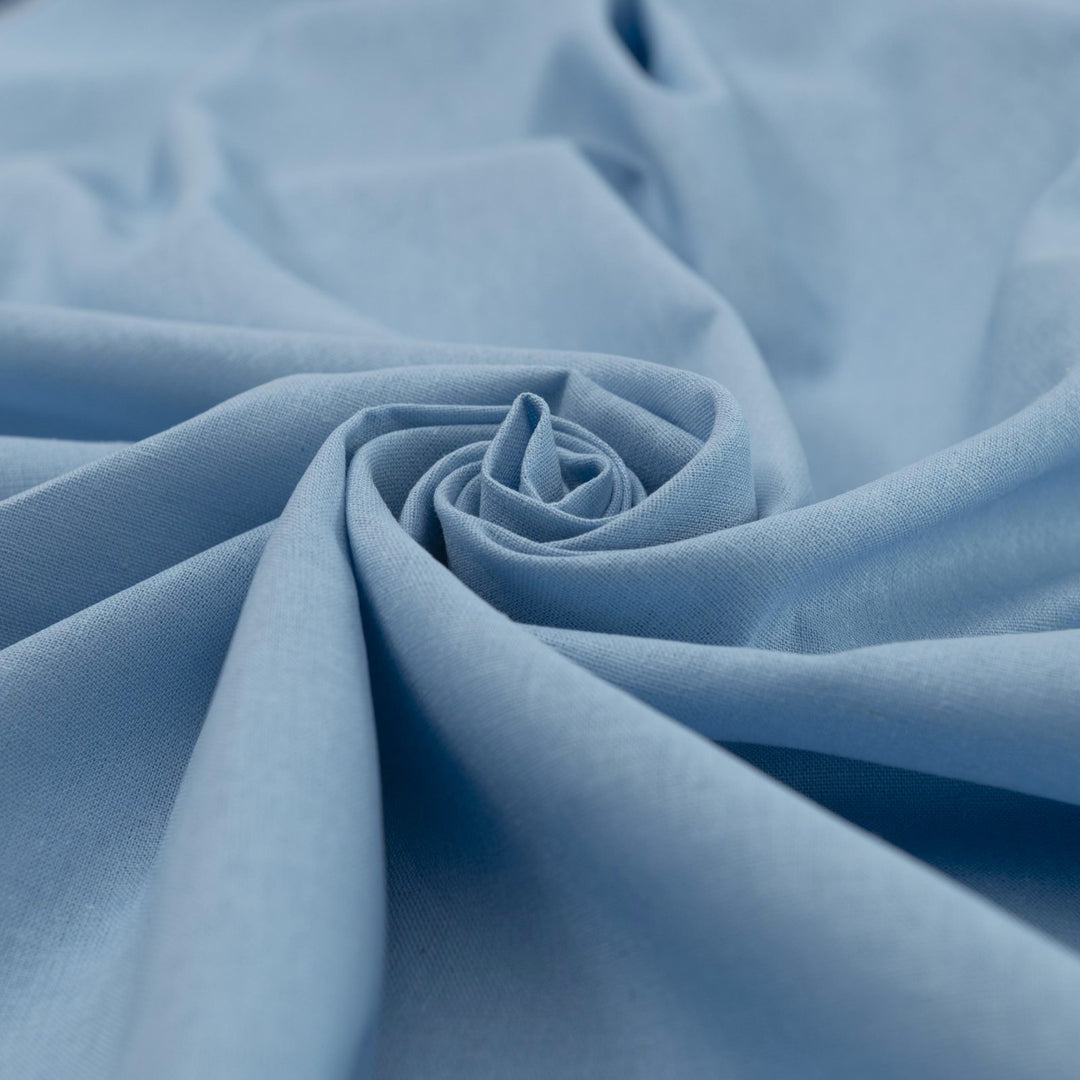 Pale blue linen and cotton blend fabric, mid-weight, soft, breathable, and opaque, perfect for sewing dresses, shirts, pants, and lightweight jackets.

