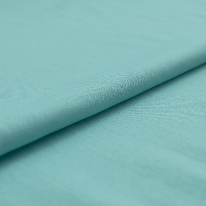 Pale jade linen and cotton blend fabric, mid-weight, soft, breathable, and opaque, ideal for sewing dresses, shirts, pants, and lightweight jackets.
