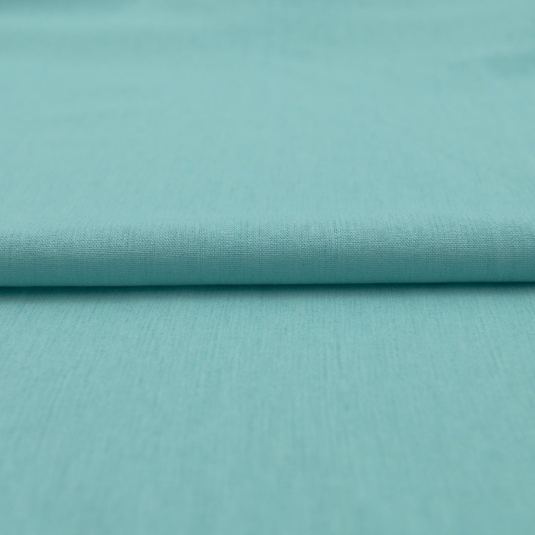 Pale jade linen and cotton blend fabric, mid-weight, soft, breathable, and opaque, ideal for sewing dresses, shirts, pants, and lightweight jackets.