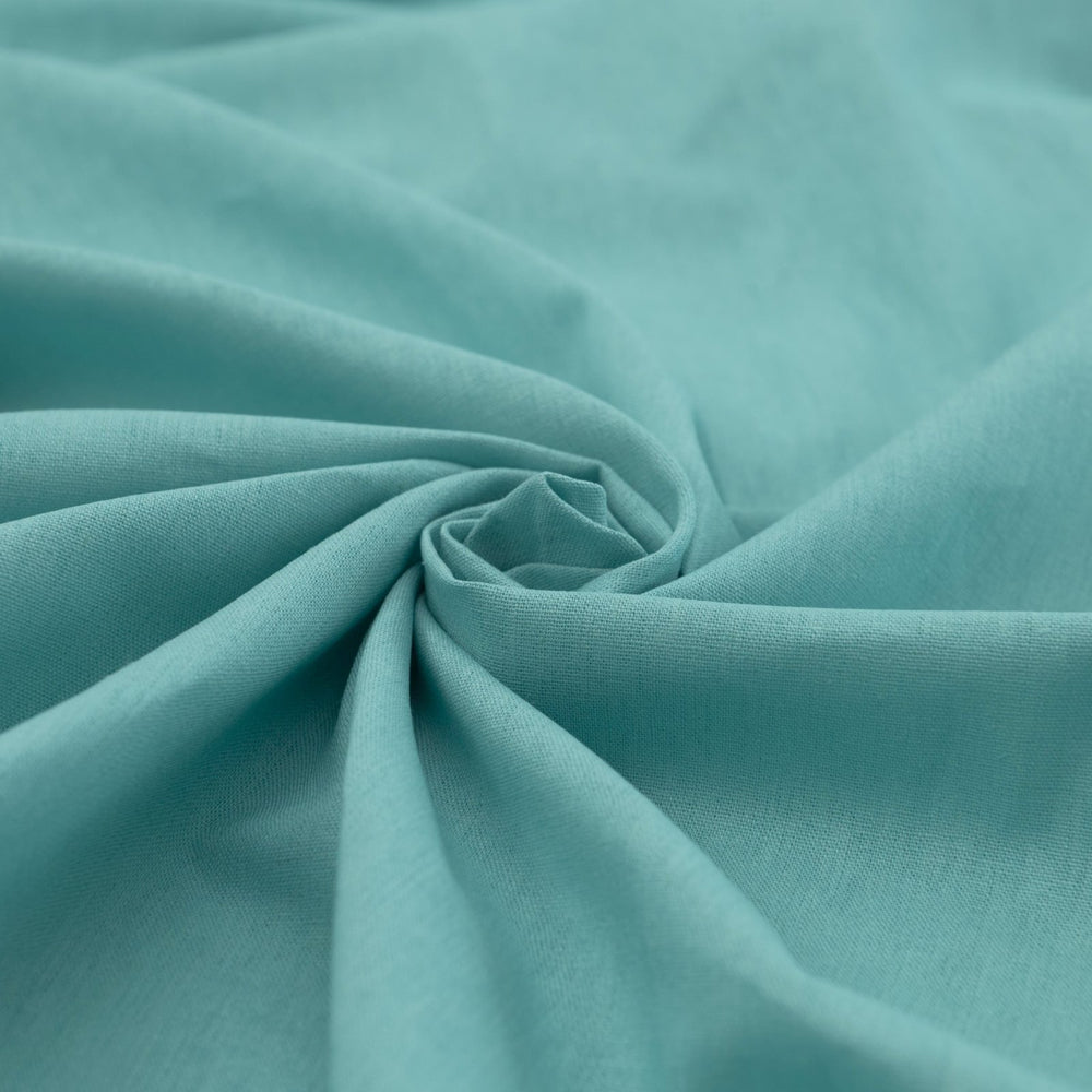 Pale jade linen and cotton blend fabric, mid-weight, soft, breathable, and opaque, ideal for sewing dresses, shirts, pants, and lightweight jackets.