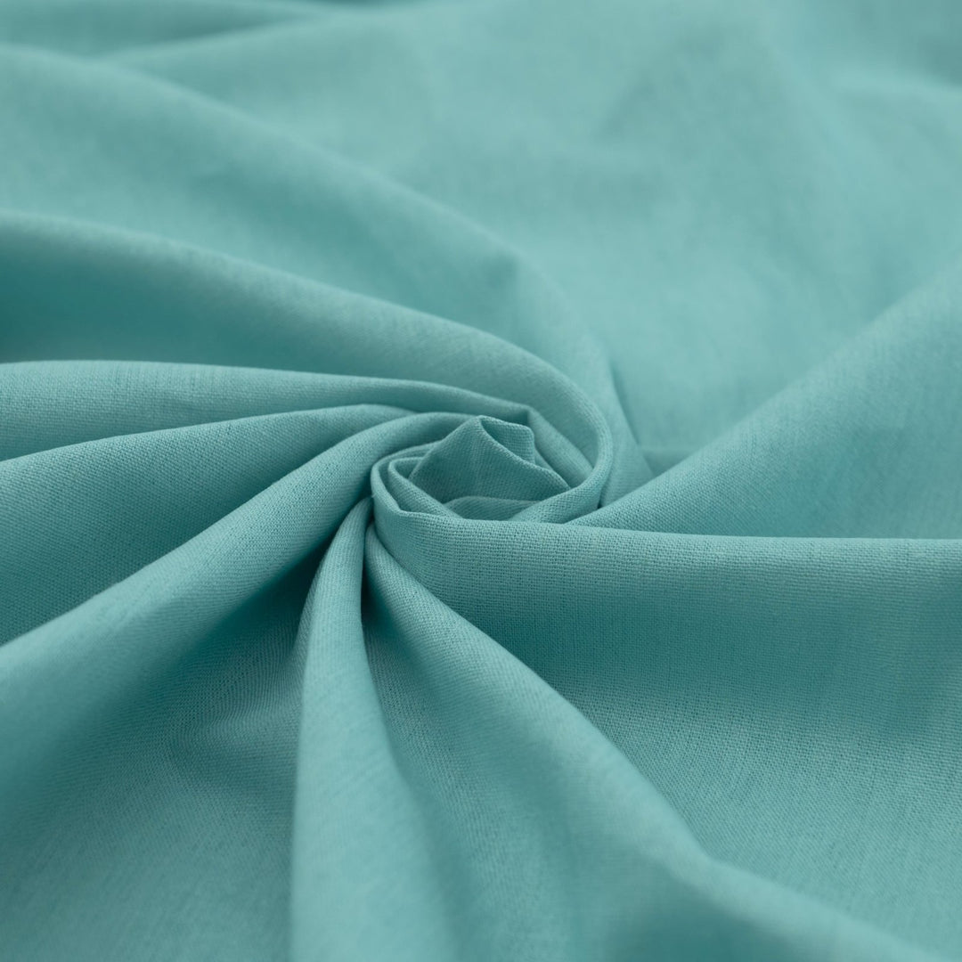 Pale jade linen and cotton blend fabric, mid-weight, soft, breathable, and opaque, ideal for sewing dresses, shirts, pants, and lightweight jackets.