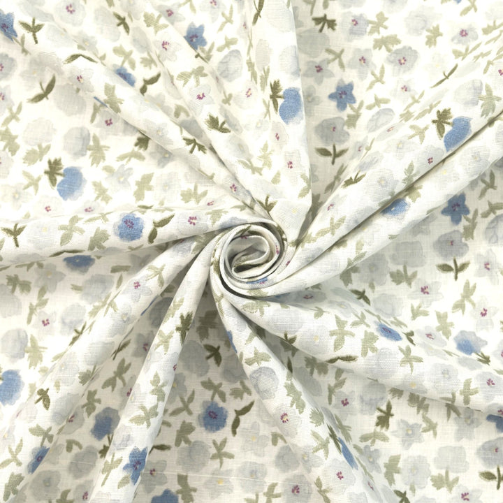 Linen and cotton blend fabric with soft blue floral pattern and green stems, 56-inch wide lightweight fabric