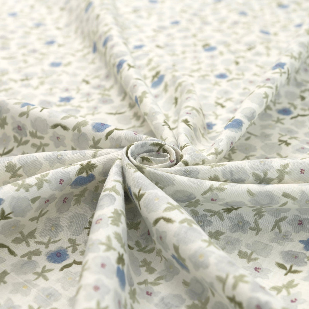 Linen and cotton blend fabric with soft blue floral pattern and green stems, 56-inch wide lightweight fabric
