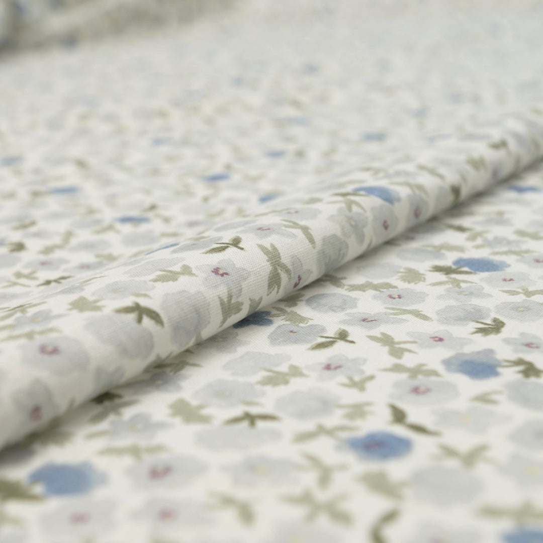 Linen and cotton blend fabric with soft blue floral pattern and green stems, 56-inch wide lightweight fabric