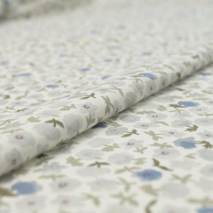 Linen and cotton blend fabric with soft blue floral pattern and green stems, 56-inch wide lightweight fabric