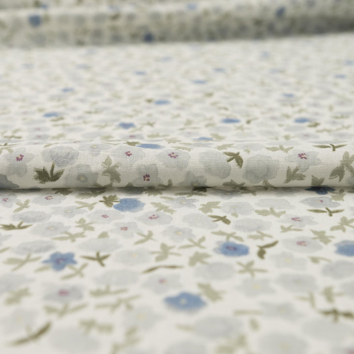 Linen and cotton blend fabric with soft blue floral pattern and green stems, 56-inch wide lightweight fabric