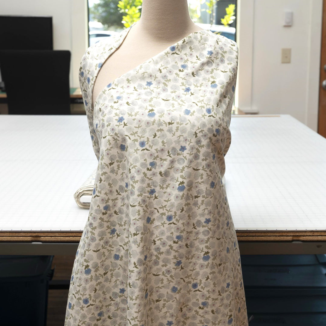 Linen and cotton blend fabric with soft blue floral pattern and green stems, 56-inch wide lightweight fabric