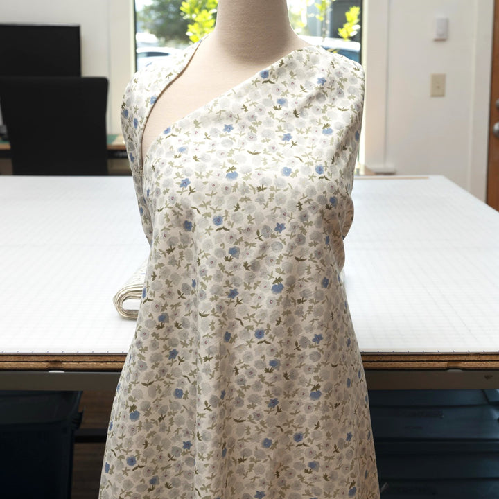 Linen and cotton blend fabric with soft blue floral pattern and green stems, 56-inch wide lightweight fabric