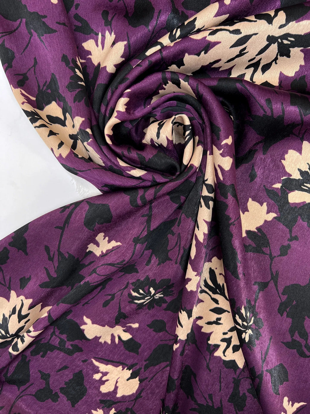 Italian dressweight sateen fabric with purple, black, and beige leaf pattern, lightweight polyester textile ideal for structured dresses, skirts, and suiting.