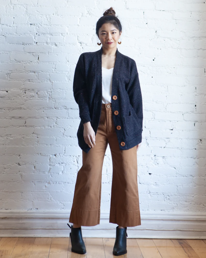 True Bias Marlo Sweater in medium-weight knit, featuring dropped shoulder, deep V-neck, wide bands, and large buttons, shown in cropped and mid-thigh length views.
