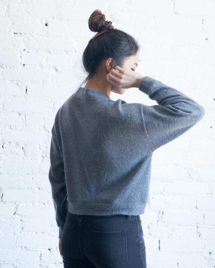 True Bias Marlo Sweater in medium-weight knit, featuring dropped shoulder, deep V-neck, wide bands, and large buttons, shown in cropped and mid-thigh length views.