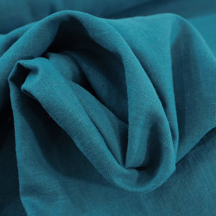 Soft Wash Linen fabric in vibrant marine blue color, 100% pre-washed linen ideal for sewing dresses, jackets, and lightweight garments.

