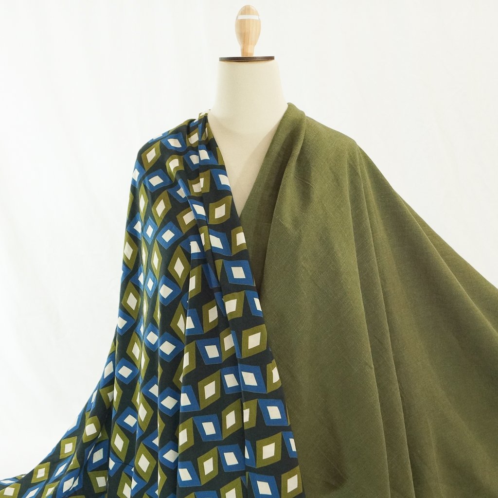 Soft Wash Linen fabric in rich olive green color, 100% pre-washed linen ideal for sewing dresses, jackets, pants, and more.

