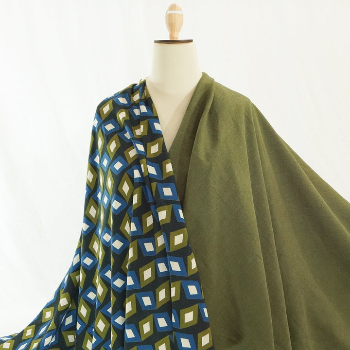 Soft Wash Linen fabric in rich olive green color, 100% pre-washed linen ideal for sewing dresses, jackets, pants, and more.

