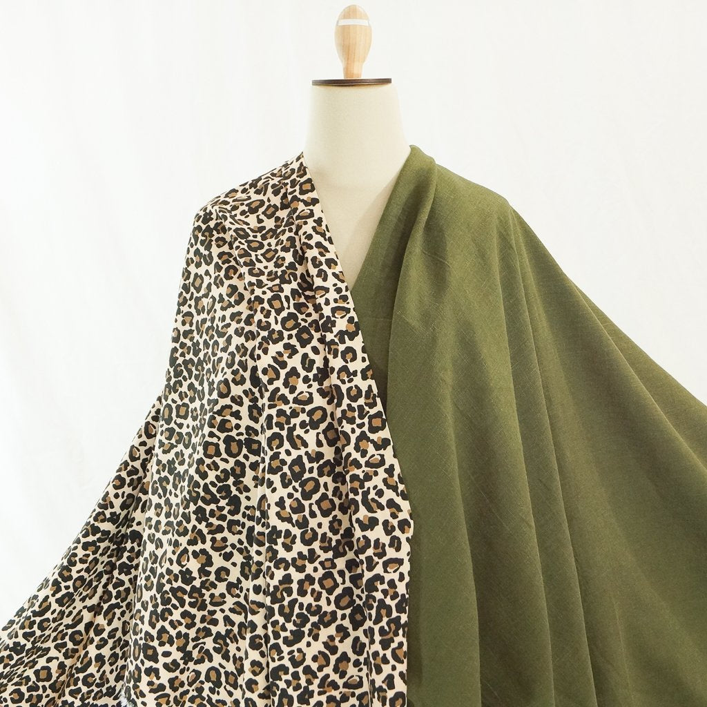 Soft Wash Linen fabric in rich olive green color, 100% pre-washed linen ideal for sewing dresses, jackets, pants, and more.

