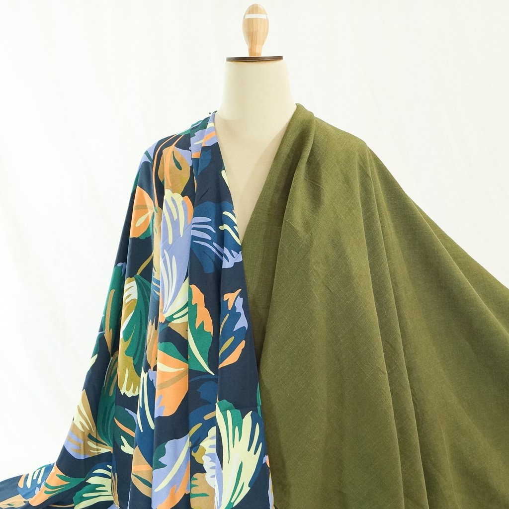 Soft Wash Linen fabric in rich olive green color, 100% pre-washed linen ideal for sewing dresses, jackets, pants, and more.

