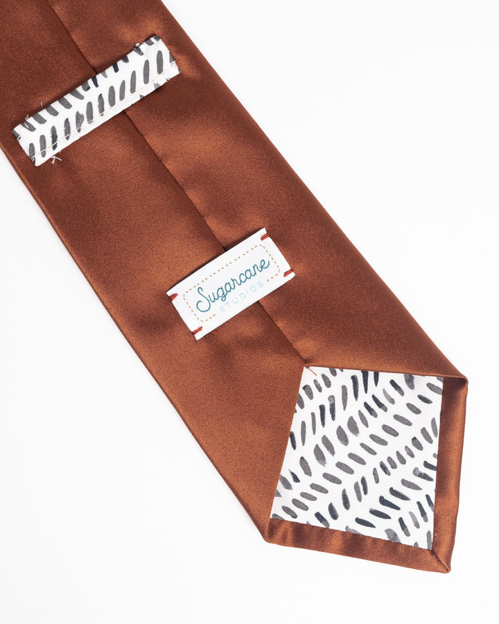 Handmade men's satin necktie in fall/winter colors with a polished finish.