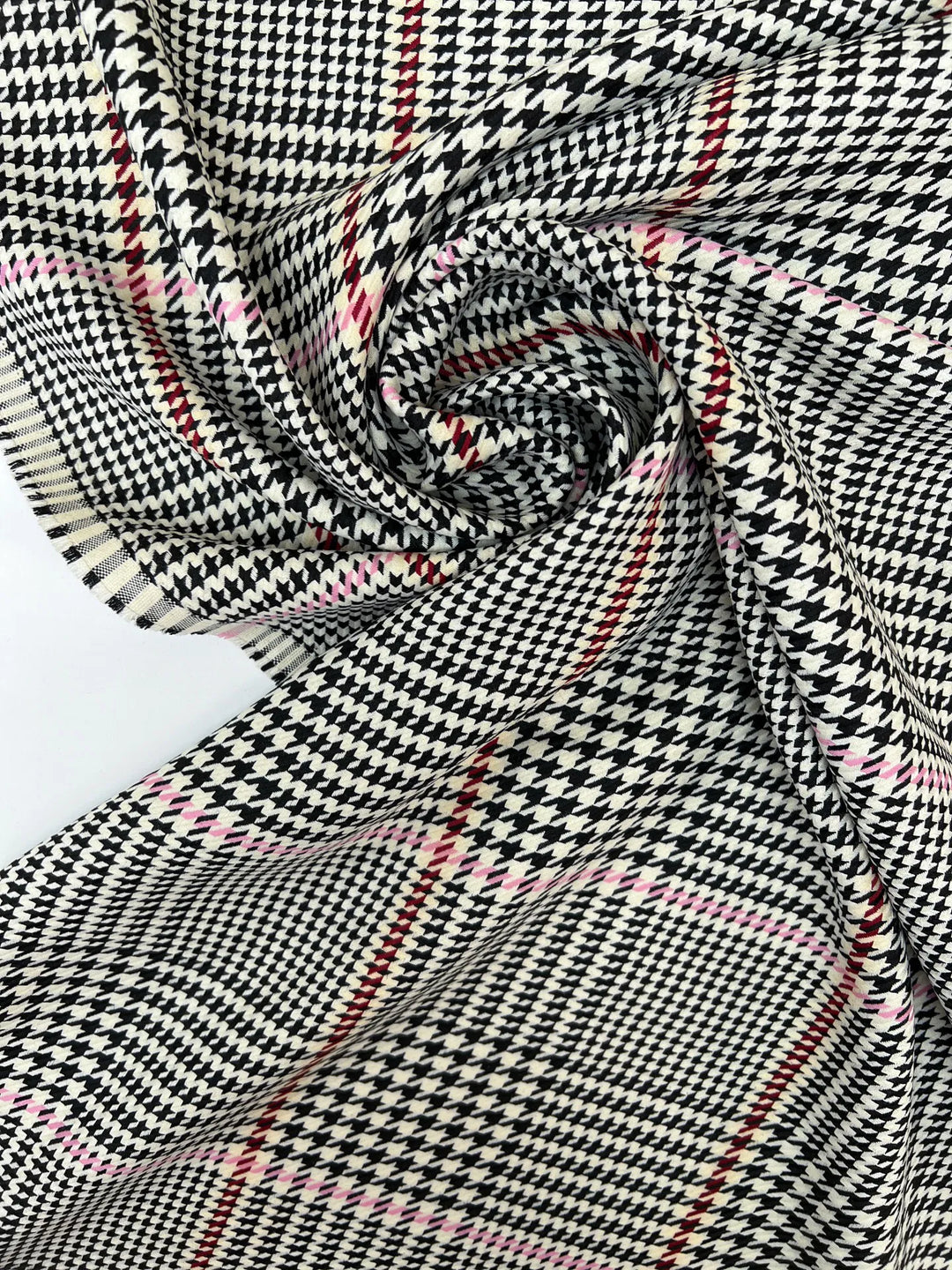 Italian houndstooth tweed fabric in cream, black, and pink, polyester wool blend, lightweight textile for coats, suiting, and structured dresses.
