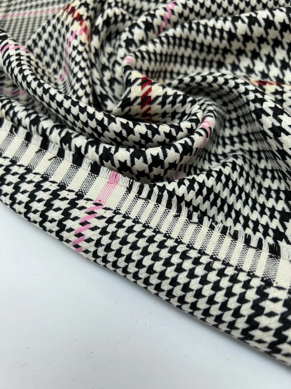 Italian houndstooth tweed fabric in cream, black, and pink, polyester wool blend, lightweight textile for coats, suiting, and structured dresses.