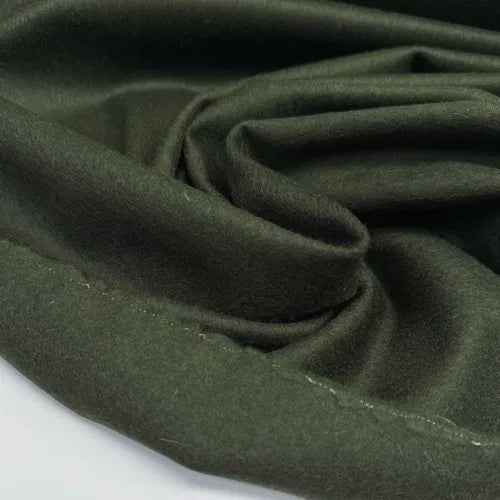 Close-up of Wool Suiting fabric in green, made from 100% Italian wool, ideal for tailored suits, skirts, and structured dresses.