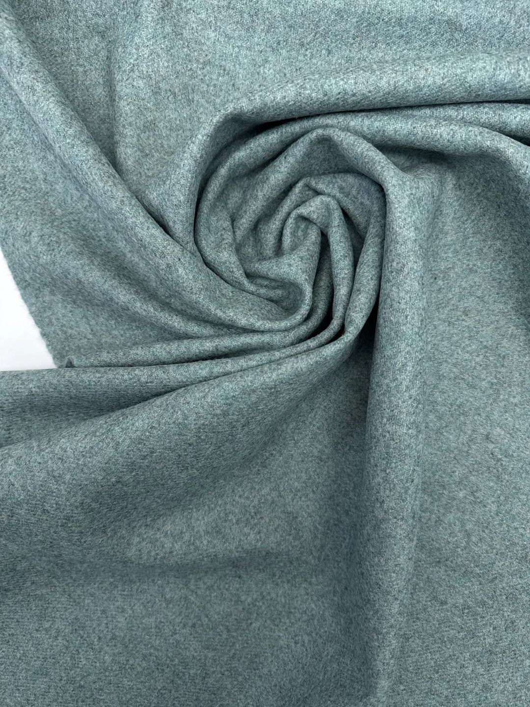 Close-up of Wool Suiting fabric in mottled slate blue, made from 100% high-quality wool, ideal for tailored suits and coats.