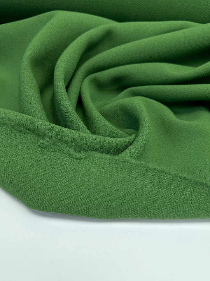 Luxurious Italian grass green wool twill fabric, perfect for coats, blazers, and suiting with strength, warmth, and timeless style.