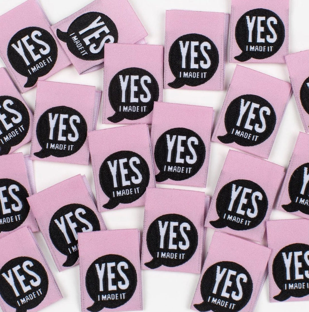 Bright pink 'Yes, I Made It' premium woven sewing labels for handmade garments and crafts