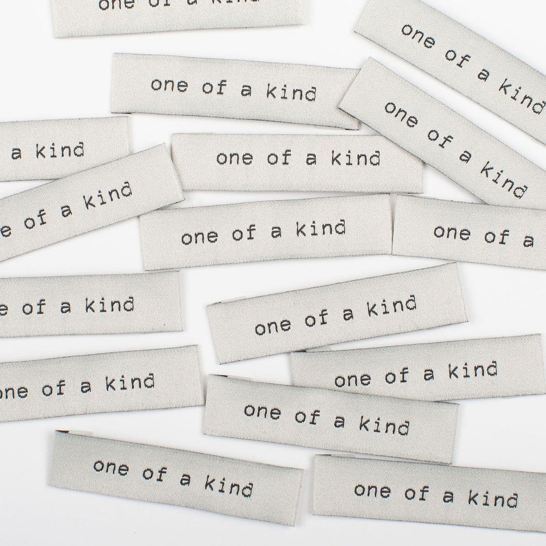Elegant 'One of a Kind' woven labels in black and beige - premium tags for unique handmade garments