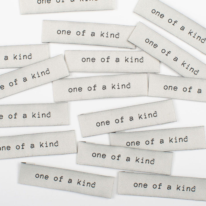 Elegant 'One of a Kind' woven labels in black and beige - premium tags for unique handmade garments