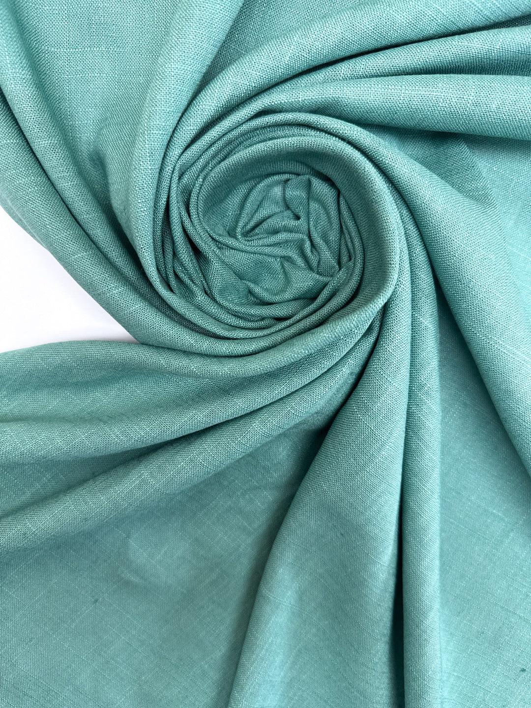 Linen Blend Shirting fabric in aqua blue-green color. Made from 78% Linen and 22% Rayon/Viscose. Ideal for shirts and blouses.