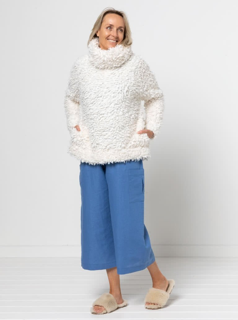 Style Arc Brooklyn Knit Top sewing pattern with oversized fit, high neck collar, side pockets, and wide cuffs