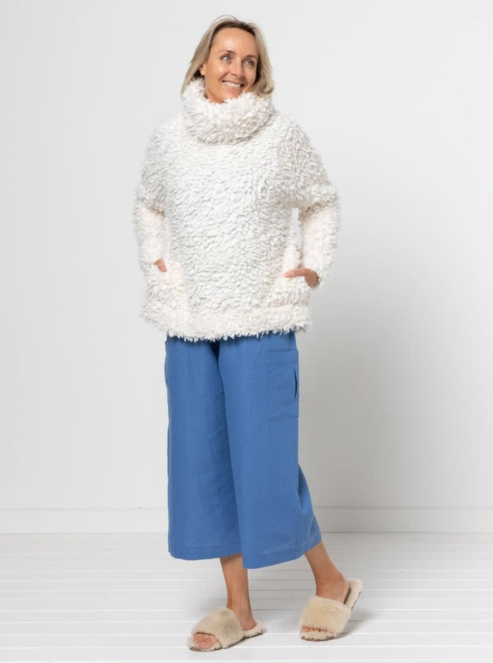 Style Arc Brooklyn Knit Top sewing pattern with oversized fit, high neck collar, side pockets, and wide cuffs
