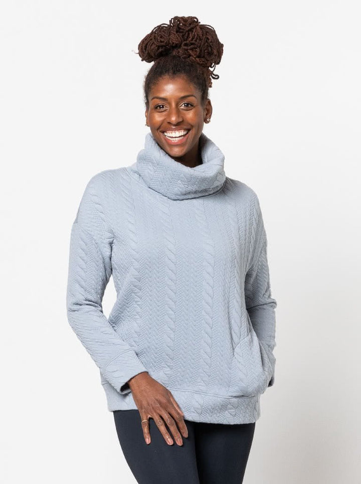 Style Arc Brooklyn Knit Top sewing pattern with oversized fit, high neck collar, side pockets, and wide cuffs
