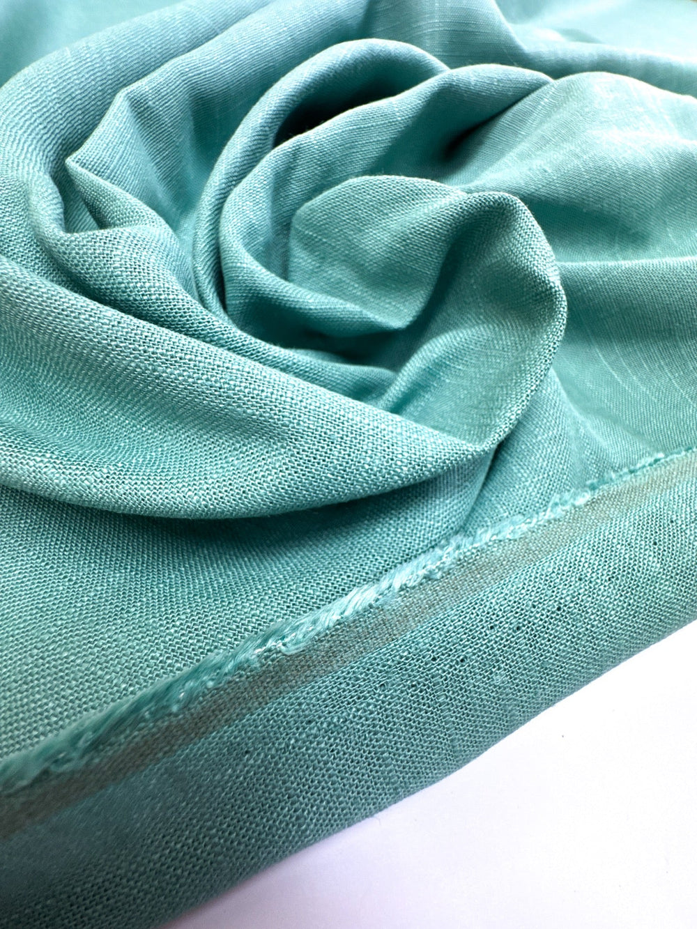Linen Blend Shirting fabric in aqua blue-green color. Made from 78% Linen and 22% Rayon/Viscose. Ideal for shirts and blouses.